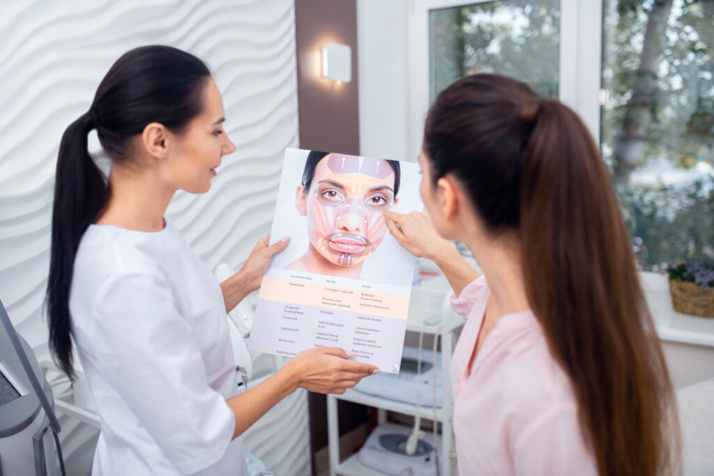 Dark haired patient asking questions about facial muscles